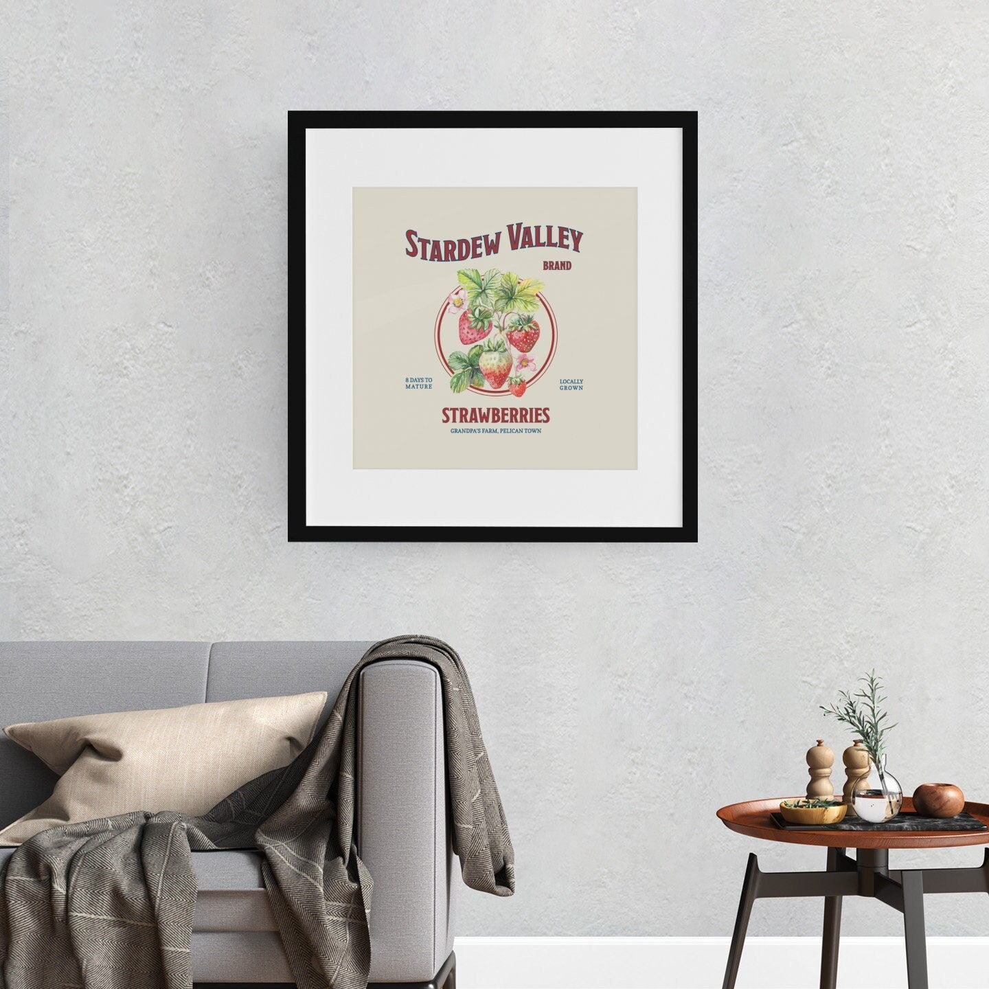 A large Stardew Valley Strawberries Print by New Save in a black frame on a living room wall.